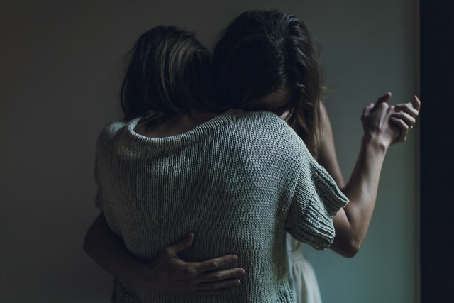 women hugging each other