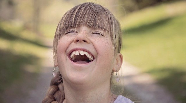 little girl smiling with eyes close