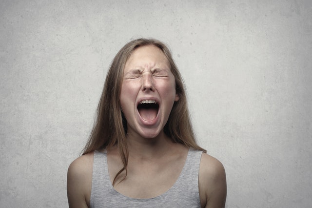 woman shouting with her eyes close