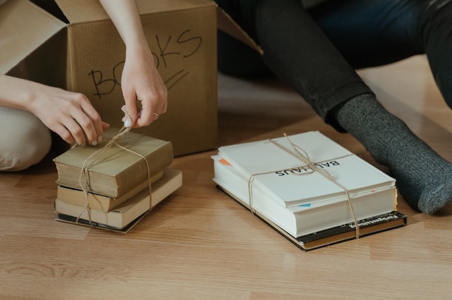 person holding brown cardboard box