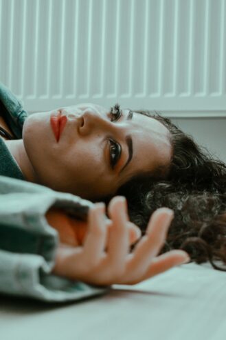 woman lying on the floor of an apartment