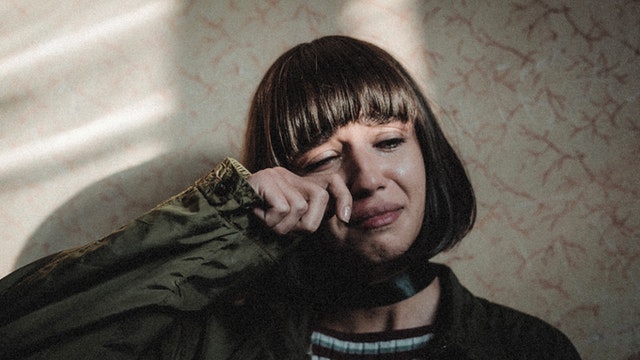 young sad woman crying at home