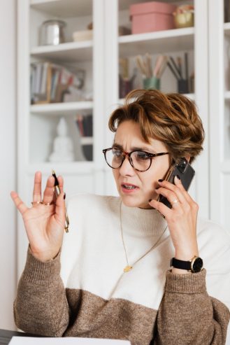 woman talking on the phone with confused face