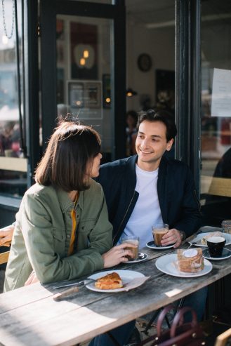 man and woman eating in a restaurant
