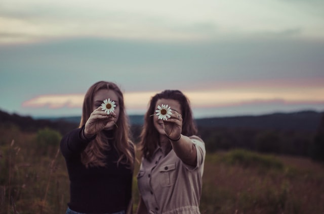 women holding a white flower