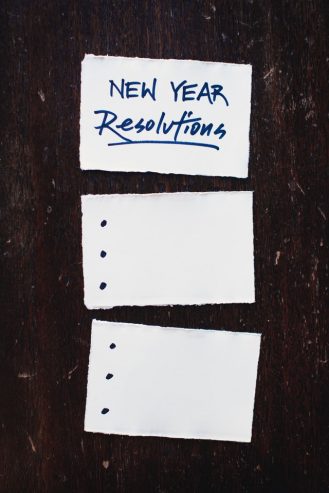 three pieces of paper on a table with new year resolutions on one page