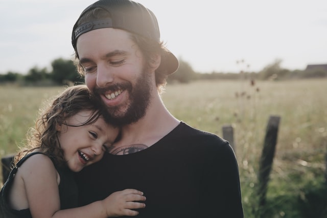 dad smiling with her daughter