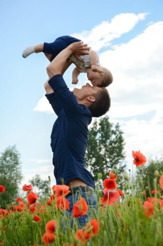 dad raising his child high up in the air