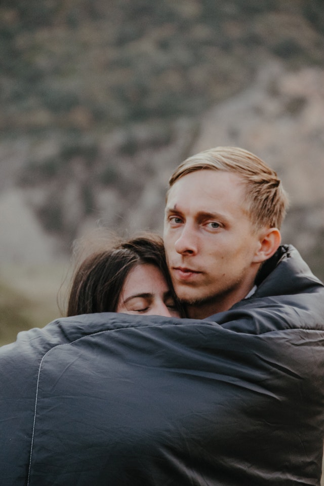 man hugging woman