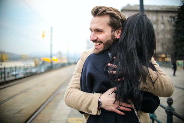 man hugging a woman