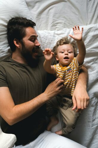 man with his son in bed