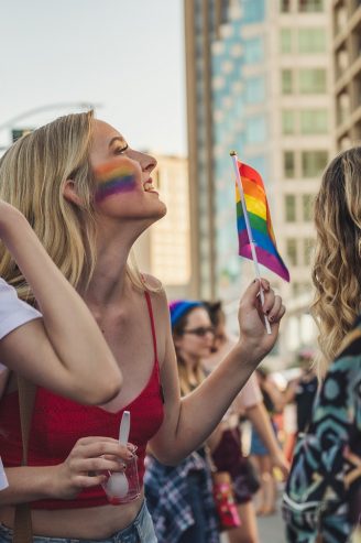 woman holding a rainbow flag