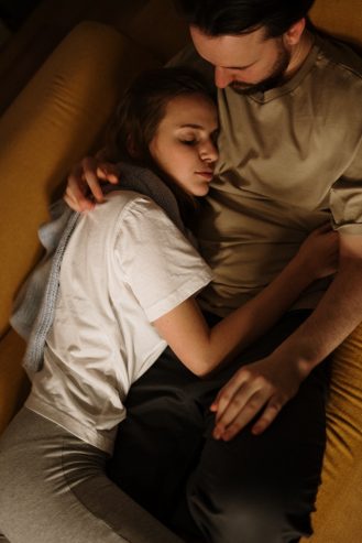 couple hugging on a couch