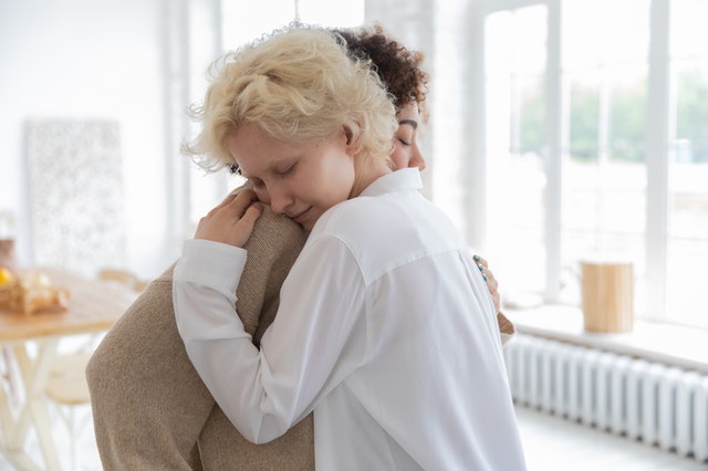 multiracial women hugging tenderly