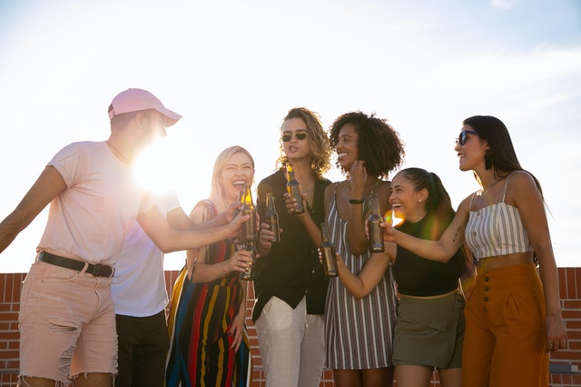 cheerful diverse friends having a party on a terrace