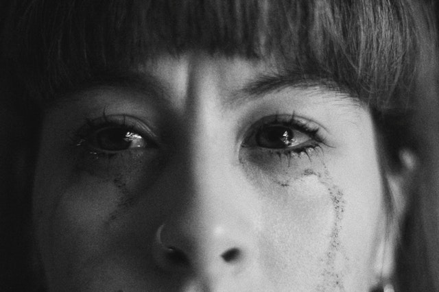 crop crying woman with smearing makeup