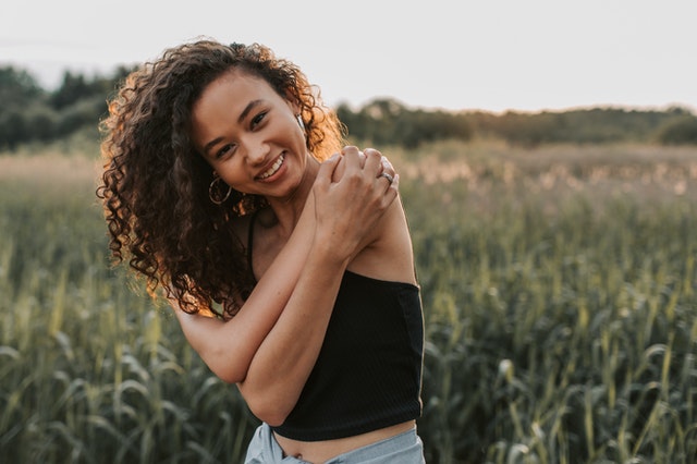 woman wearing black top smiling