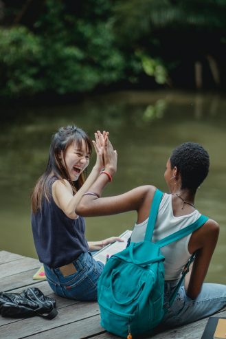 laughing women on wooden bridge