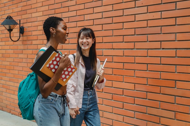 multiracial students talking after class