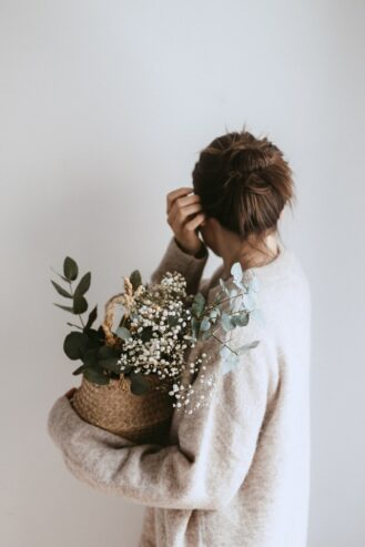 woman holding a basket of flowers